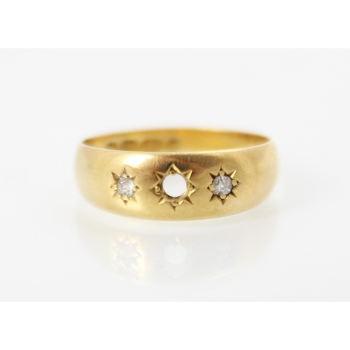 245 - An 18ct yellow gold diamond set gypsy ring, with two old cut diamonds set within engraved star desig... 