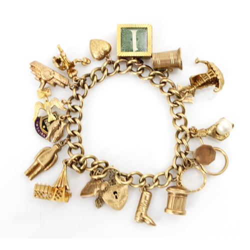 256 - A 9ct yellow gold charm bracelet, the curb link bracelet suspending seventeen gold coloured charms i... 