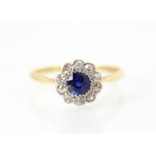 257 - An Edwardian style untested sapphire and diamond cluster ring, the round cut sapphire within a surro... 