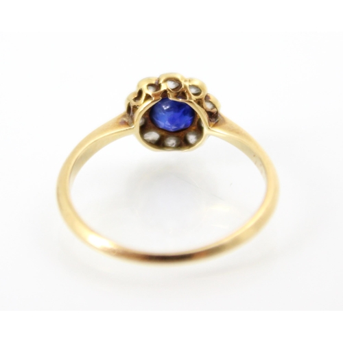 257 - An Edwardian style untested sapphire and diamond cluster ring, the round cut sapphire within a surro... 