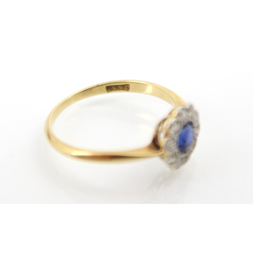 257 - An Edwardian style untested sapphire and diamond cluster ring, the round cut sapphire within a surro... 