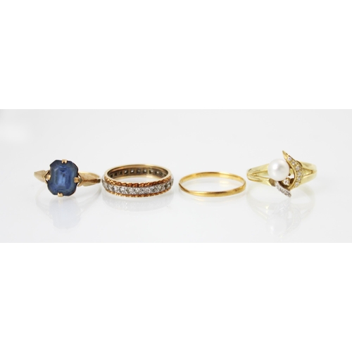 260 - A group of four rings, including a yellow metal wedding band, marks worn, ring size P, a yellow meta... 