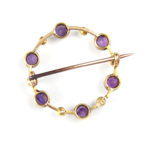 292 - An early 20th century amethyst and seed pearl brooch, the circular openwork brooch with round cut am... 