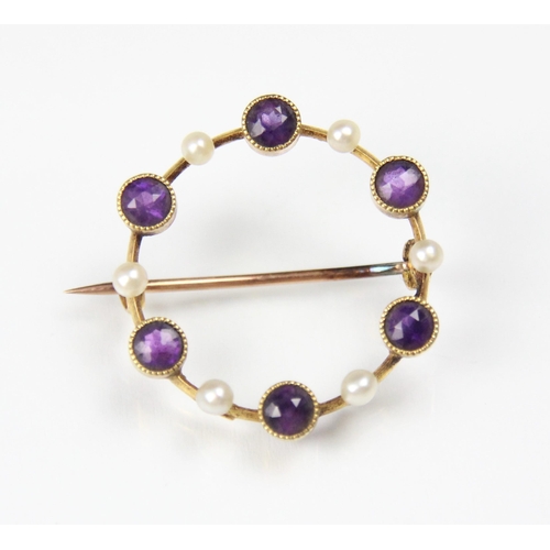 292 - An early 20th century amethyst and seed pearl brooch, the circular openwork brooch with round cut am... 