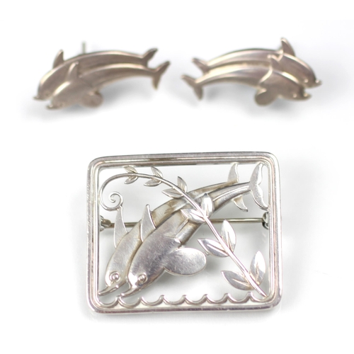 294 - A Georg Jensen dolphin brooch, designed by Arno Malinowski, the two dolphins leaping above stylised ... 