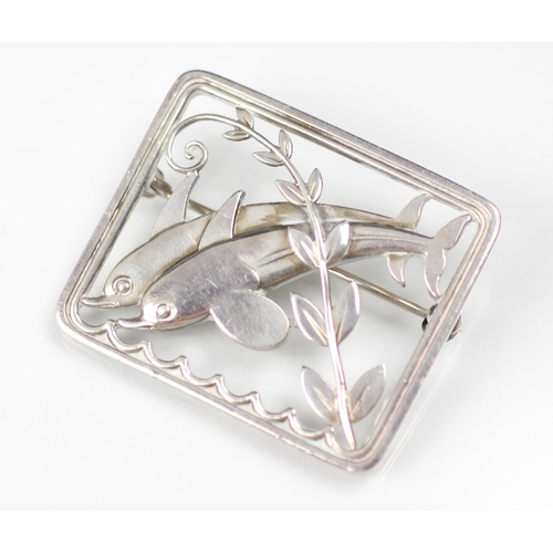 294 - A Georg Jensen dolphin brooch, designed by Arno Malinowski, the two dolphins leaping above stylised ... 