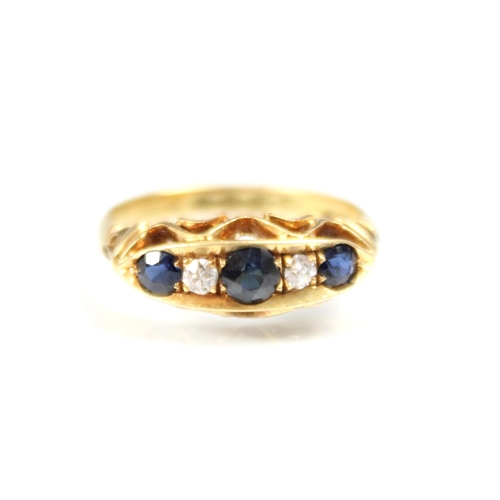 307 - An early 20th century sapphire and diamond five stone ring, the three graduated round cut sapphires ... 