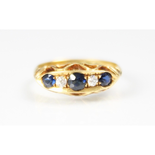 307 - An early 20th century sapphire and diamond five stone ring, the three graduated round cut sapphires ... 