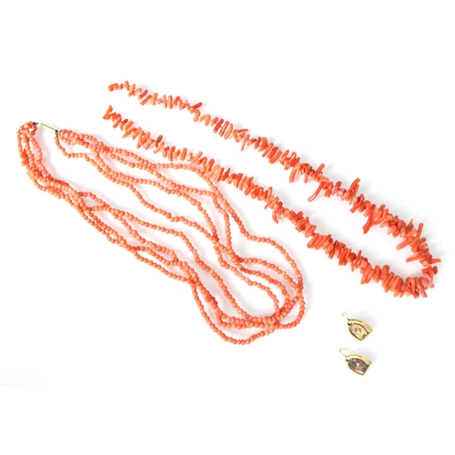 312 - A triple row coral necklace, the plain polished spherical beads with stamped barrel clasp, overall l... 