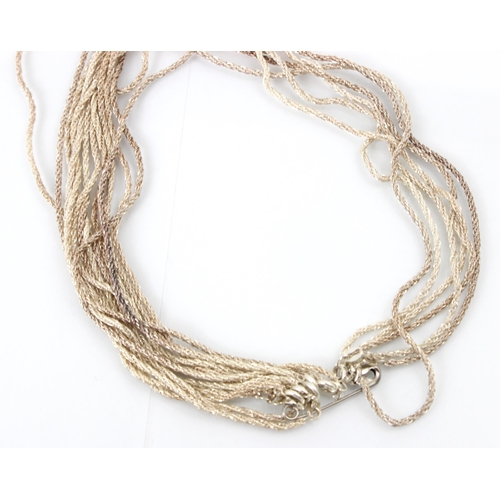 313 - A group of nine white metal necklaces, designed as twisted wirework necklaces with bolt ring fasteni... 