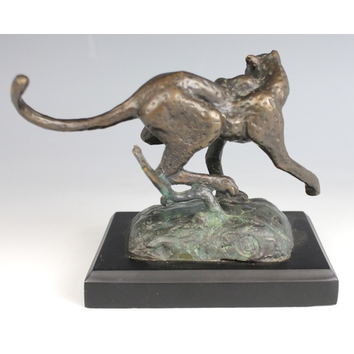 369 - A patinated bronze model of a cheetah, 20th century, modelled running with tail raised, monogrammed ... 