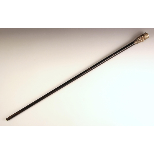 386 - A Burmese silver topped walking cane, 19th century, the tapered ebonised cane terminating with a hea... 