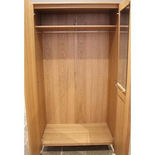 628 - An Ercol Savona light oak two door wardrobe, late 20th/early 21st century, opening to an internal mi... 