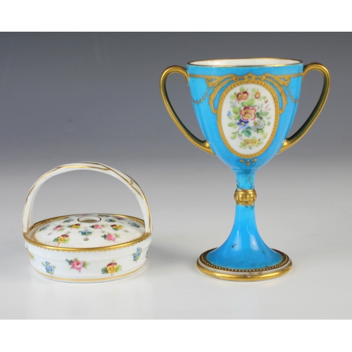 679 - A Minton turquoise twin handled cup, early 20th century, with a polychrome floral reserve to one sid... 