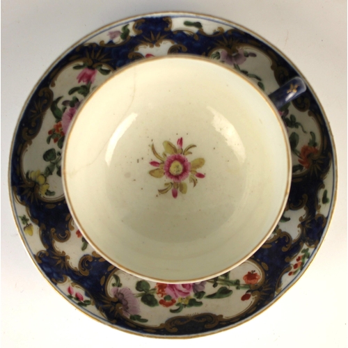 683 - A Worcester first period teacup and saucer, circa 1770, decorated with floral reserves to a cobalt g... 