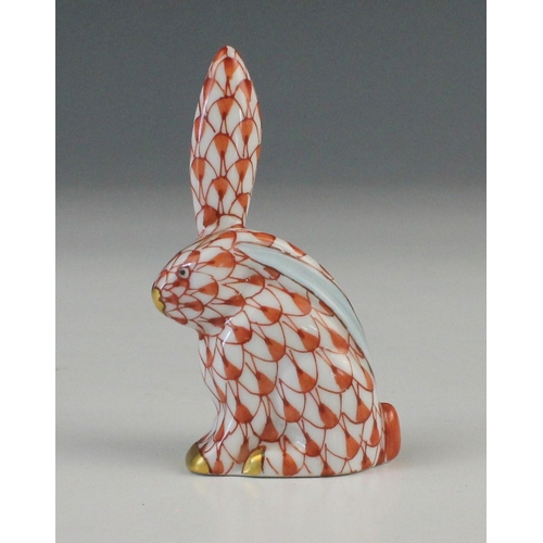 685 - A Herend porcelain model of a hare, 20th century, decorated in the Vieux Herend red fishnet design w... 