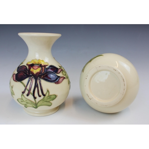 694 - A pair of Moorcroft Columbine pattern vases, 20th century, of globular form with flared neck, impres... 