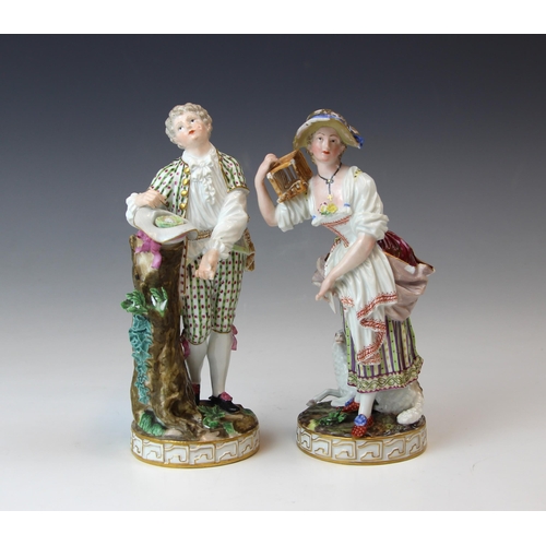 713 - A near pair of German porcelain figures, 19th century, modelled as a shepherdess holding a letter, s... 