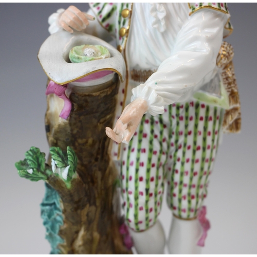 713 - A near pair of German porcelain figures, 19th century, modelled as a shepherdess holding a letter, s... 