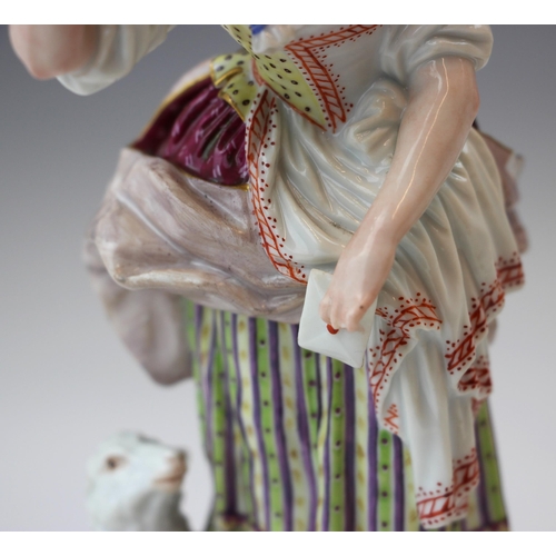 713 - A near pair of German porcelain figures, 19th century, modelled as a shepherdess holding a letter, s... 