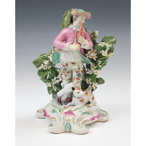 714 - A British porcelain figure, 19th century, possibly Derby modelled as a man playing the flute with a ... 