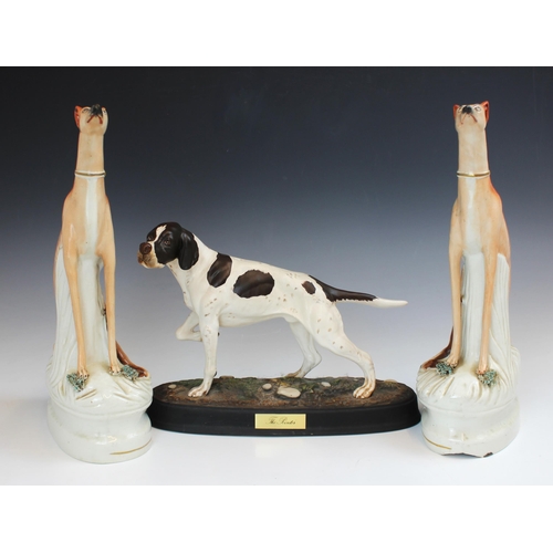 723 - A pair of Staffordshire greyhounds, 19th century, modelled seated, beside a tree stump with caught g... 