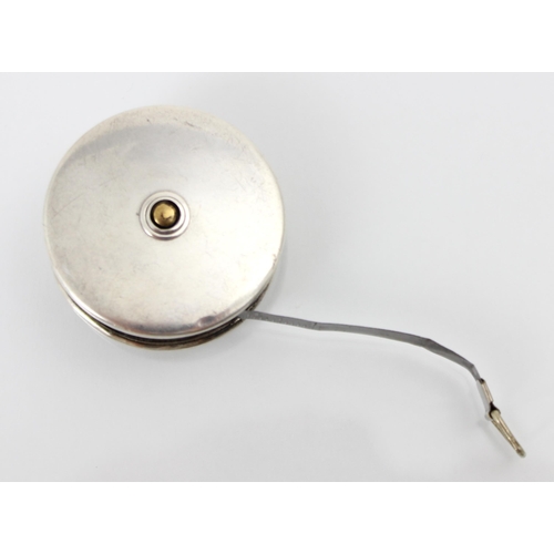 81 - A George V silver and white metal tape measure Crisford and Norris, Birmingham 1914, of circular pla... 