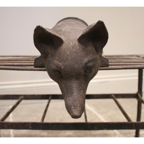 820 - A Victorian cast iron wall mounted bridle/saddle rack, of curved form, surmounted with a cast foxes ... 