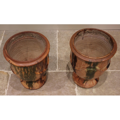 869 - A near pair of French Provence glazed stoneware planters/urns, of tapering cylindrical form with a s... 