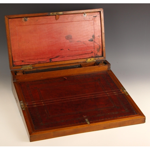 952 - A 19th century mahogany campaign writing box, applied with brass corner brackets and inset side swin... 