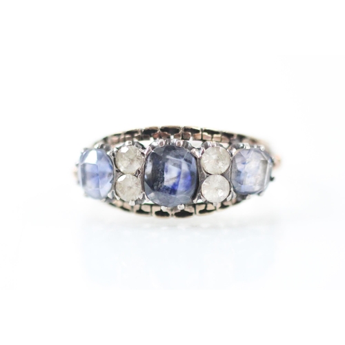 169 - An untested sapphire and paste ring, the three mixed cut sapphires interspersed with paste, set with... 