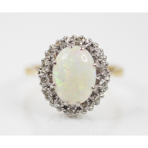 176 - A mid-20th century white opal and diamond cluster ring, the oval cabochon opal in white metal double... 