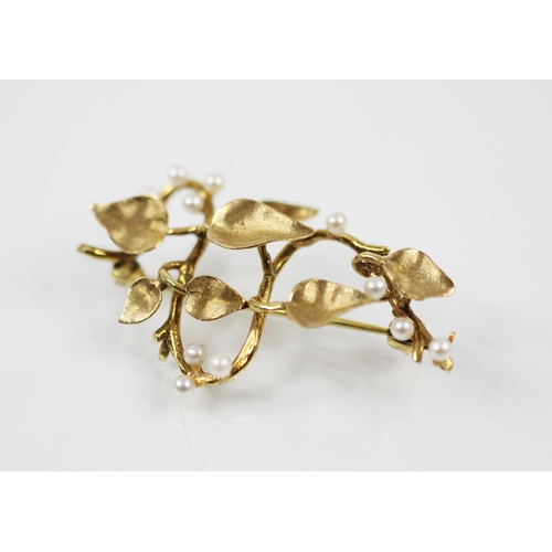 177 - A late 20th century 9ct yellow gold and seed pearl spray brooch, the plain polished stylised stem wi... 