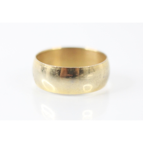 186 - A yellow metal wedding band, the wide band of plain polished form, ring size O, 3gms along with a co... 