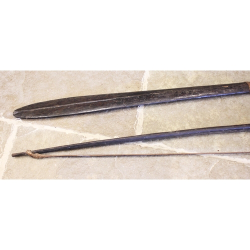 365 - A Papua New Guinea palm wood paddle club, 123cm long, with a Papua New Guinea palm wood bow with bam... 