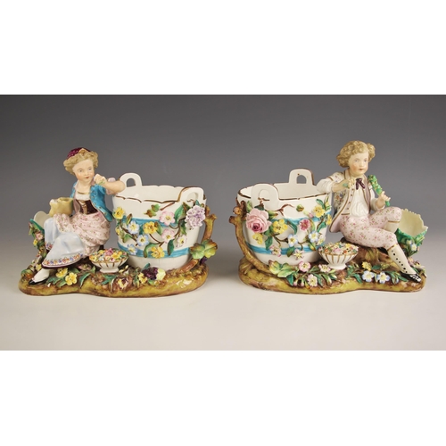 657 - A pair of continental porcelain florally encrusted figural potpourris, 19th century, one modelled as... 