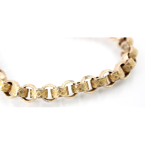 151 - A yellow metal watch chain, the faceted links interspersed with engraved links, suspending 'T-bar' a... 