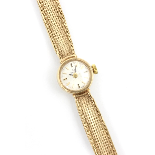 152 - An Omega 9ct yellow gold ladies wrist watch, the circular cream dial with baton markers, set to plai... 