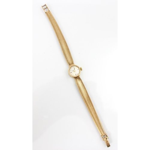 152 - An Omega 9ct yellow gold ladies wrist watch, the circular cream dial with baton markers, set to plai... 