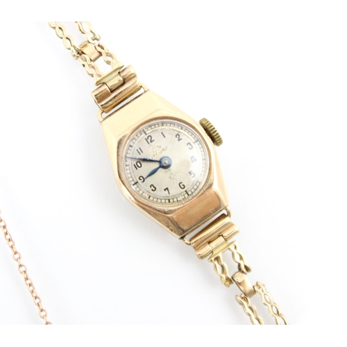 153 - An Art Deco style yellow metal ladies Record wrist watch, the champagne coloured dial with Arabic nu... 