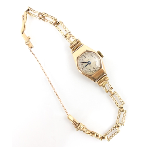 153 - An Art Deco style yellow metal ladies Record wrist watch, the champagne coloured dial with Arabic nu... 