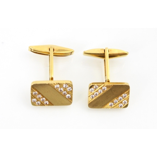 180 - A pair of yellow metal and diamond cufflinks, the rectangular cufflinks set with twelve round cut di... 