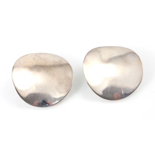 181 - A pair of white metal earrings, the circular plain polished discs with clip fastenings to reverse, s... 