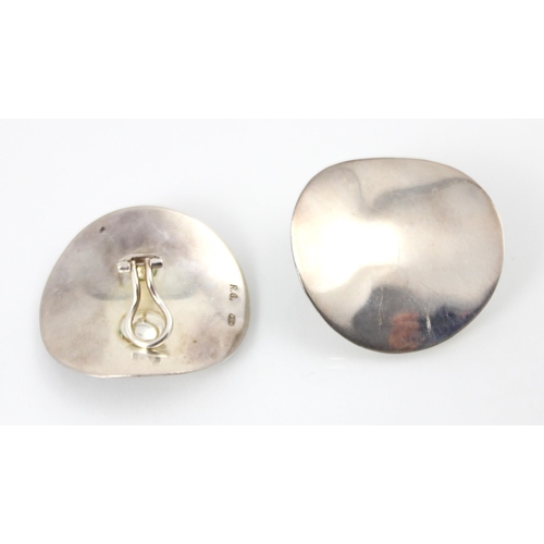 181 - A pair of white metal earrings, the circular plain polished discs with clip fastenings to reverse, s... 