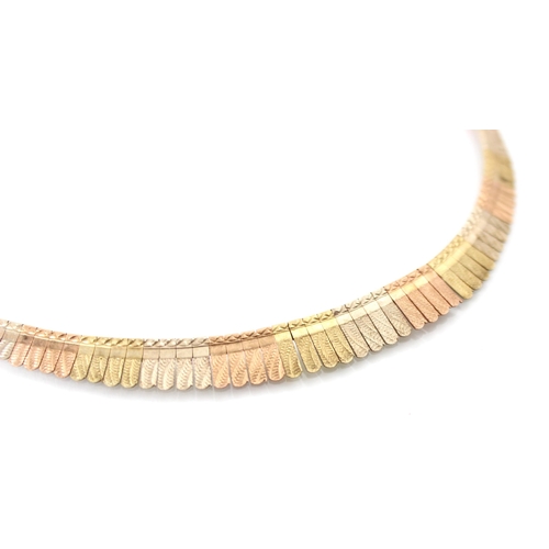 202 - A multi tone 9ct yellow gold collar necklace, the necklace designed as a fringe with planished gradu... 