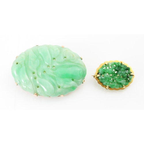 208 - A Birks Ellis ‘jade’ brooch, the carved oval panel with scalloped edge depicting floral detail, with... 