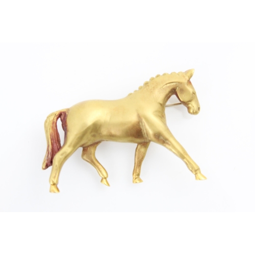 214 - An 18ct yellow horse brooch, the realistically modelled horse striding out with matte detailed body,... 