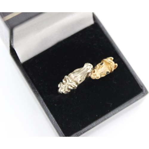 216 - A 9ct yellow gold two tone dress ring, the ring designed as two horses head terminals with twisted s... 