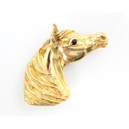 219 - A 9ct yellow gold novelty horse brooch, the brooch modelled as head of a horse with inset black glas... 