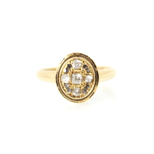 237 - An early 20th century 18ct yellow gold diamond ring, the central oval head set with old cuts and ros... 